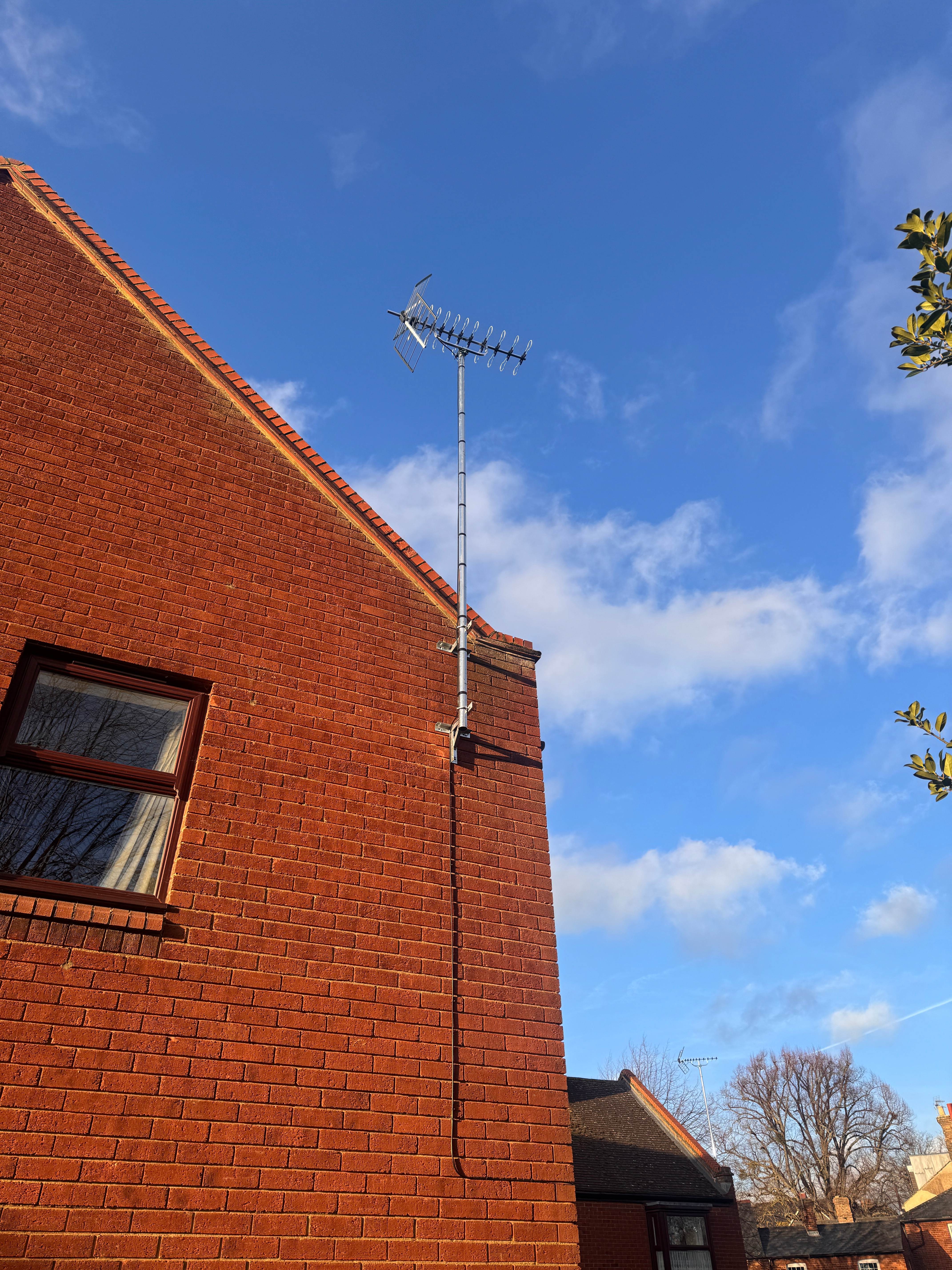 Professional TV aerial installation on brick house in Bedford