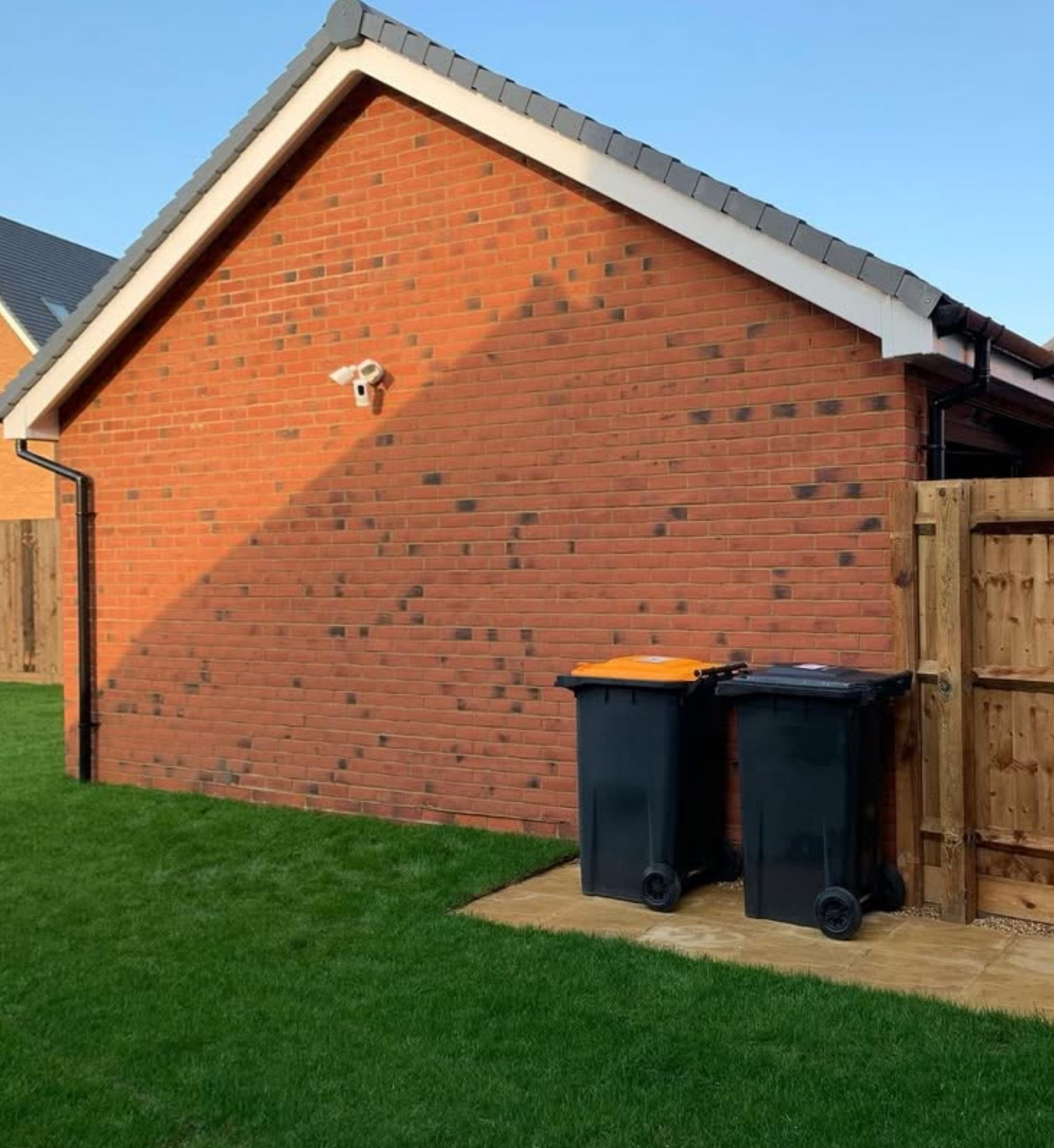 Ring floodlight camera on brick wall