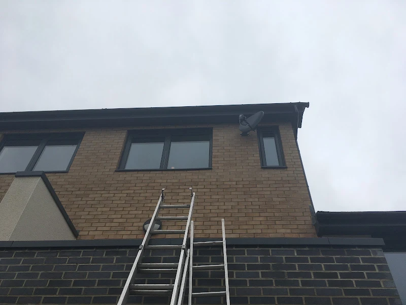 Sky satellite dish mounted on brick wall