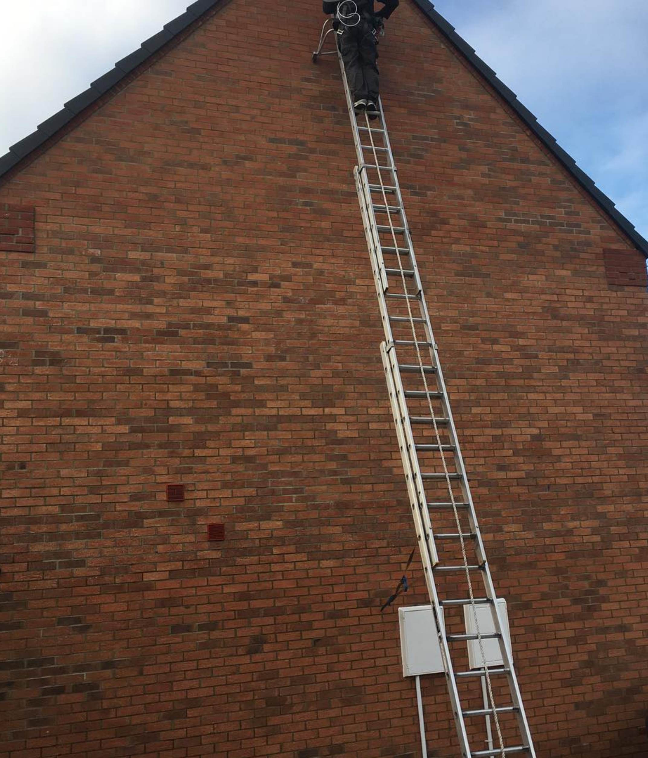 Engineer working at height on ladder